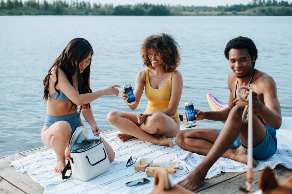 Friends gathered for a meal on the beach , highlighting the benefits of social connections to improve your heart health.