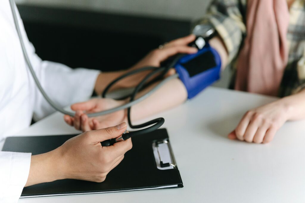 Person checking their blood pressure at home to monitor and improve your heart health