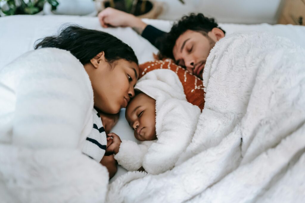 A family sleeping peacefully showing how you can also improve your heart health through better sleep quality